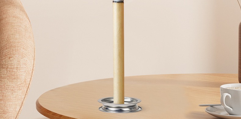A roll burning upright on a stand on a table (manufacturer detail photo).