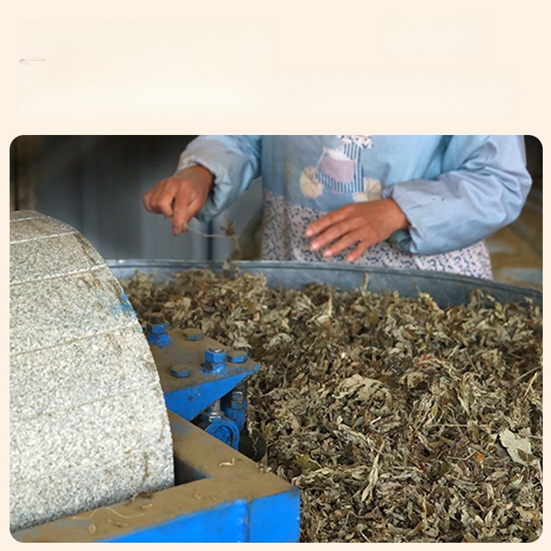 Mugwort leaves under a stone mill